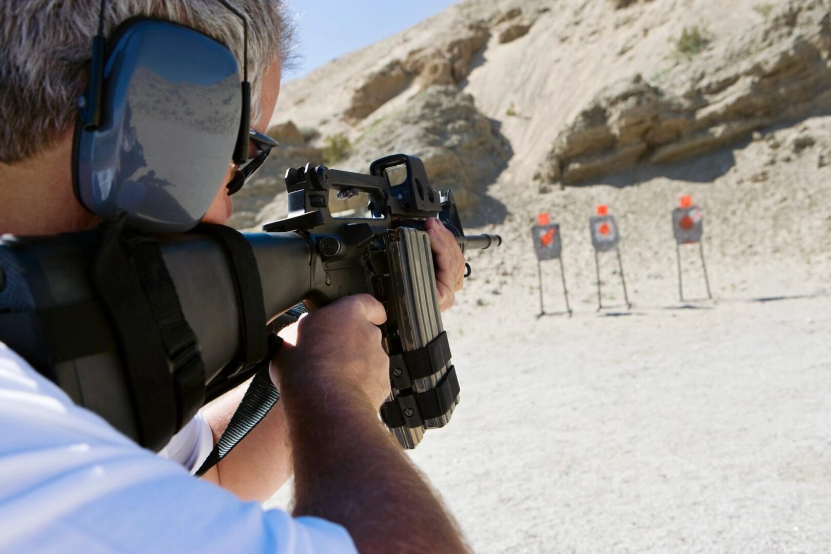 Man aiming gun at firing range