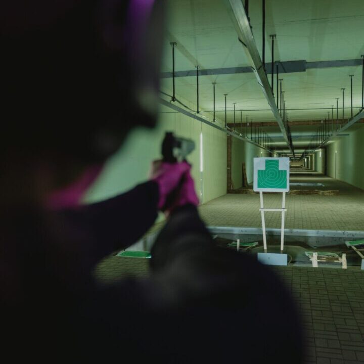 A person trying to shoot a gun from a distance